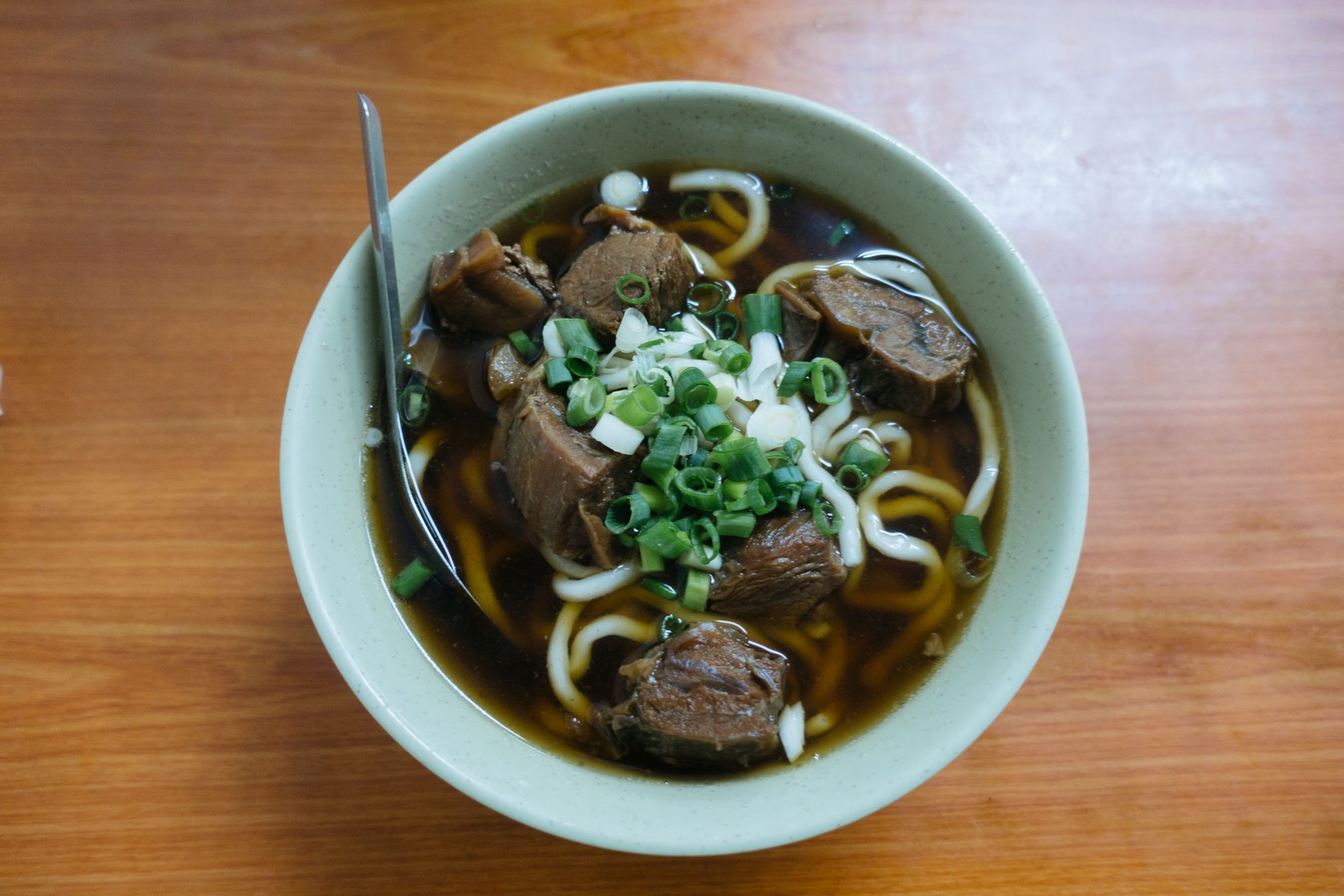 一碗牛肉面特写,清晰可见大块牛肉和汤汁